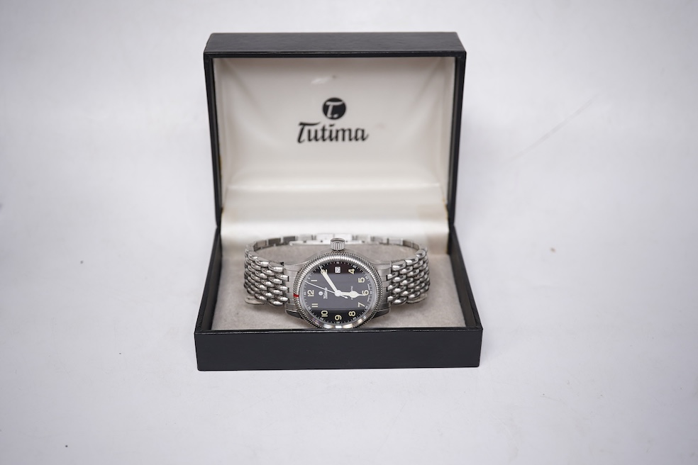 A gentleman's German stainless steel Tutima Flieger Automatic wrist watch, with black Arabic luminous dial and date aperture, cased diameter 36mm, on a stainless steel Tutima bracelet, with box and pamphlet. Condition -